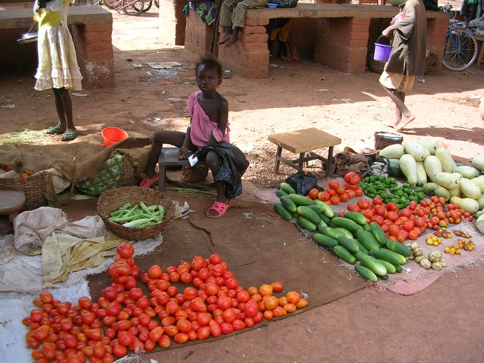 A young girl in the vegetable market