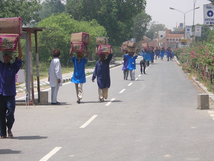 Indian bearers carrying goods
