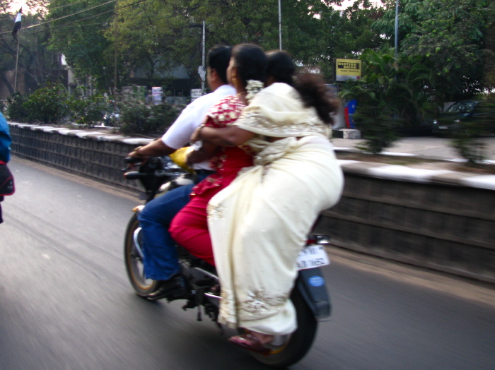 Three people on a motorbike