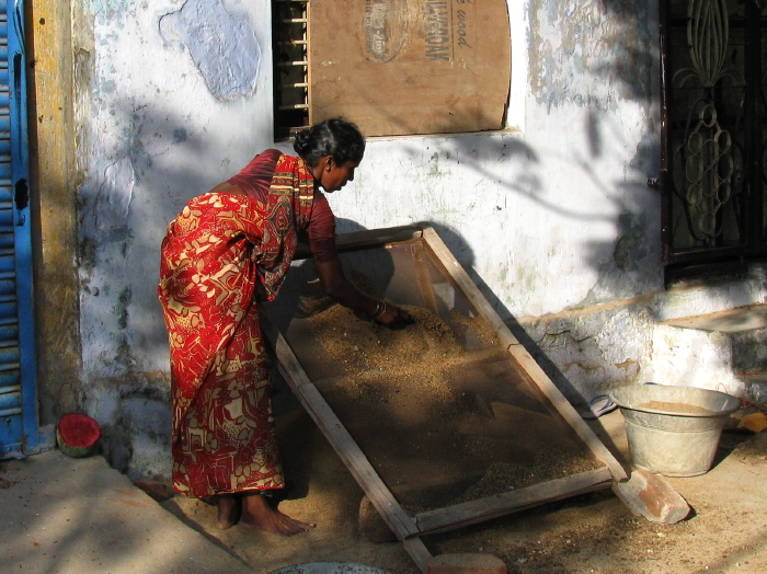 Indian woman working with a sieve