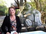 Michèle in front of a laughing Buddha
