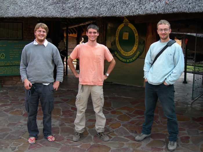Antoine, Manuel & Sylvain in front of the park entry of the zimbabwean side